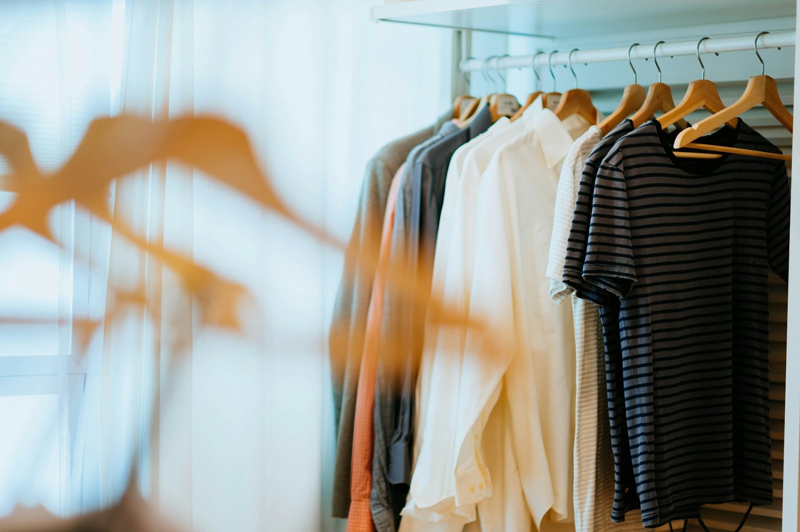 Clothes organized on matching hangers in a closet