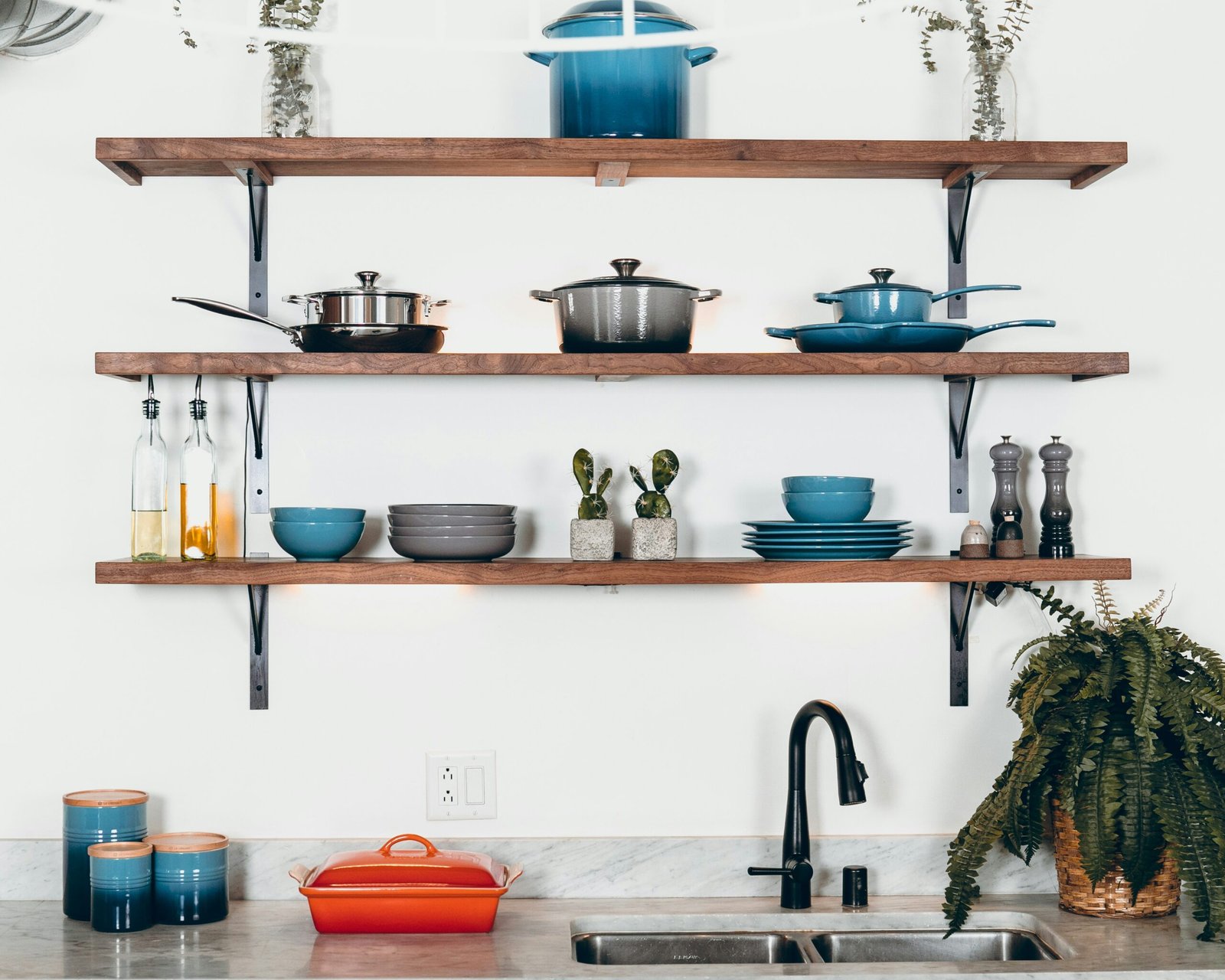 Open kitchen shelves organized by cookware and everyday kitchen items