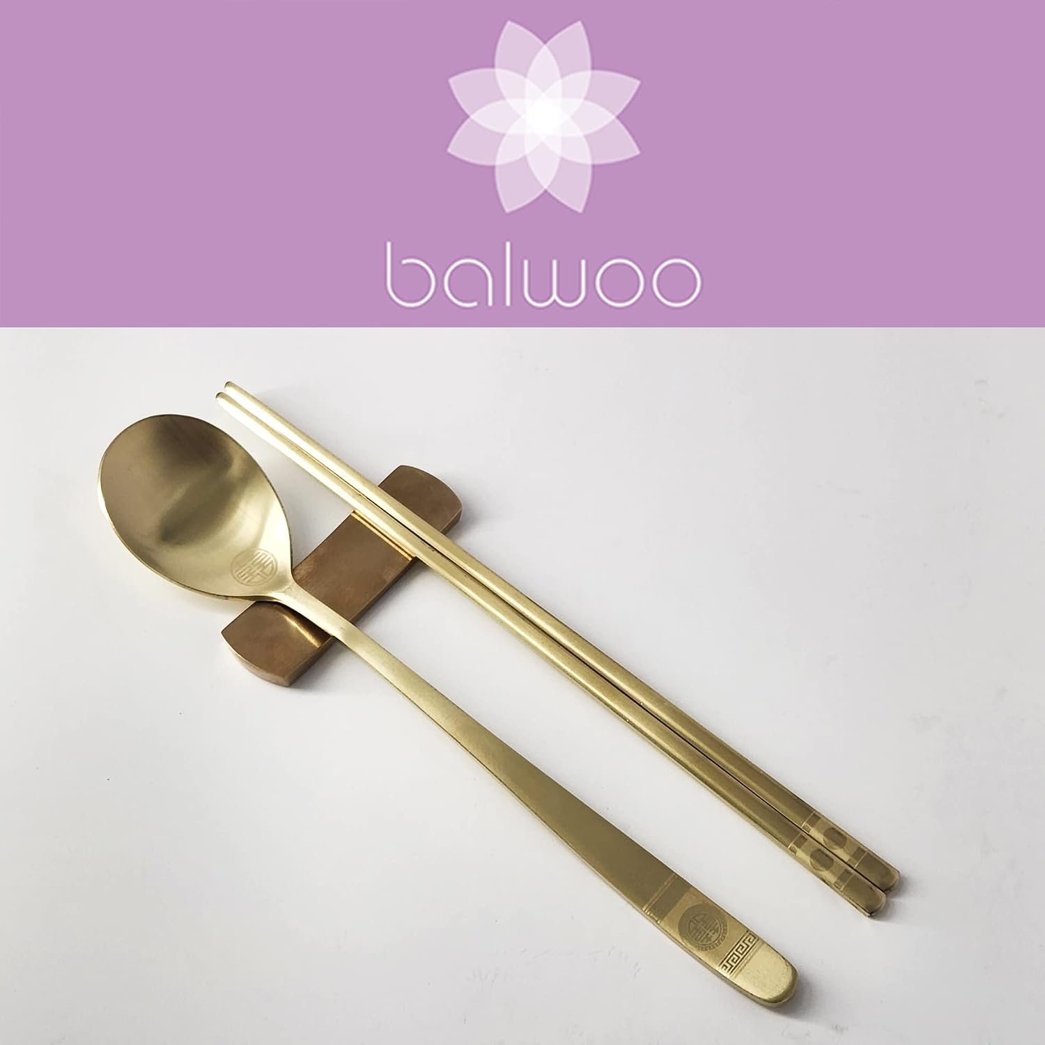 Korean Gold Titanium Cutlery Set resting on a traditional rest for cozy family dining